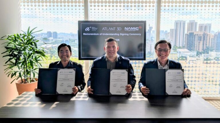 Three representatives present signed documents at a partnership meeting.