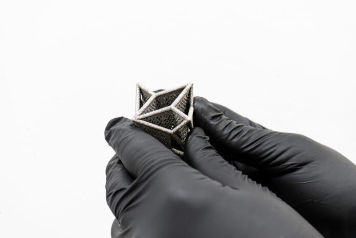 PHASE3D_DAY01_147 3D printed part held by hands with gloves