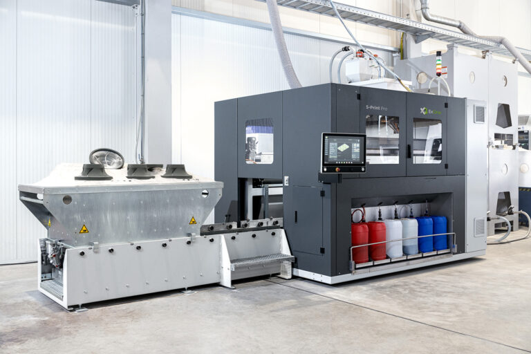 An ExOne industrial sand 3D printing system in a workshop.