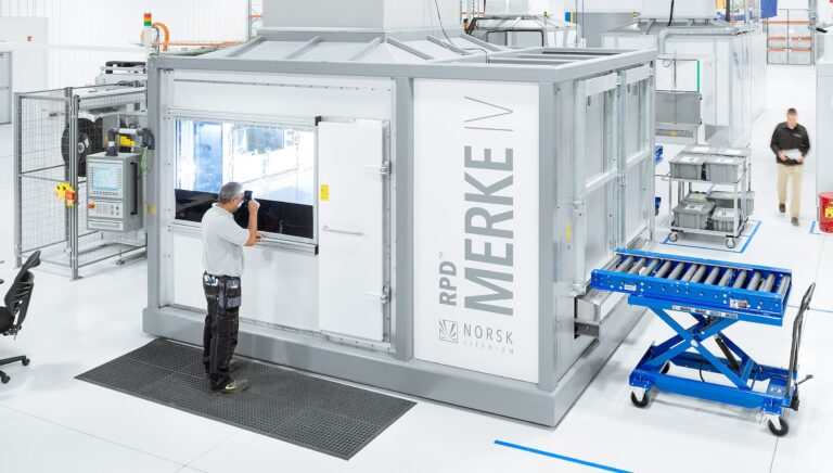 Rendering of a Norsk Titanium production installation with enclosed deposition machines.