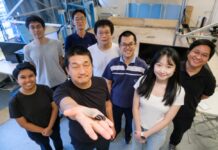 When additive manufacturing helps living machines breathe underwater Image: NTU Prof Hirotaka Sato (2nd from left), pioneer of the cyborg insect technology, holding a cyborg Madagascar hissing cockroach with the new diving suit, which has an oxygen generator, enabling the insect to survive underwater for three hours.