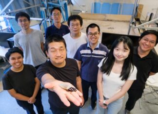Image: NTU Prof Hirotaka Sato (2nd from left), pioneer of the cyborg insect technology, holding a cyborg Madagascar hissing cockroach with the new diving suit, which has an oxygen generator, enabling the insect to survive underwater for three hours.