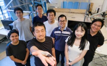 Image: NTU Prof Hirotaka Sato (2nd from left), pioneer of the cyborg insect technology, holding a cyborg Madagascar hissing cockroach with the new diving suit, which has an oxygen generator, enabling the insect to survive underwater for three hours.