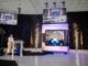 AMPERA Founder and CEO Brian Matthews pulls curtain revealing the first full-scale 3D printed reactor module, featuring a fully 3D printed silicon carbide reactor core and reactor pressure vessel at a celebratory event at the company’s innovation center in Palm Beach Gardens, Fla. (PRNewsfoto/AMPERA)