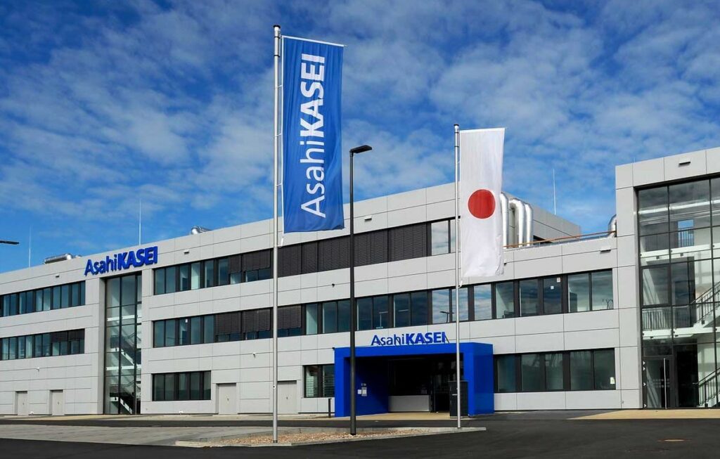 Asahi Kasei building with company flags.