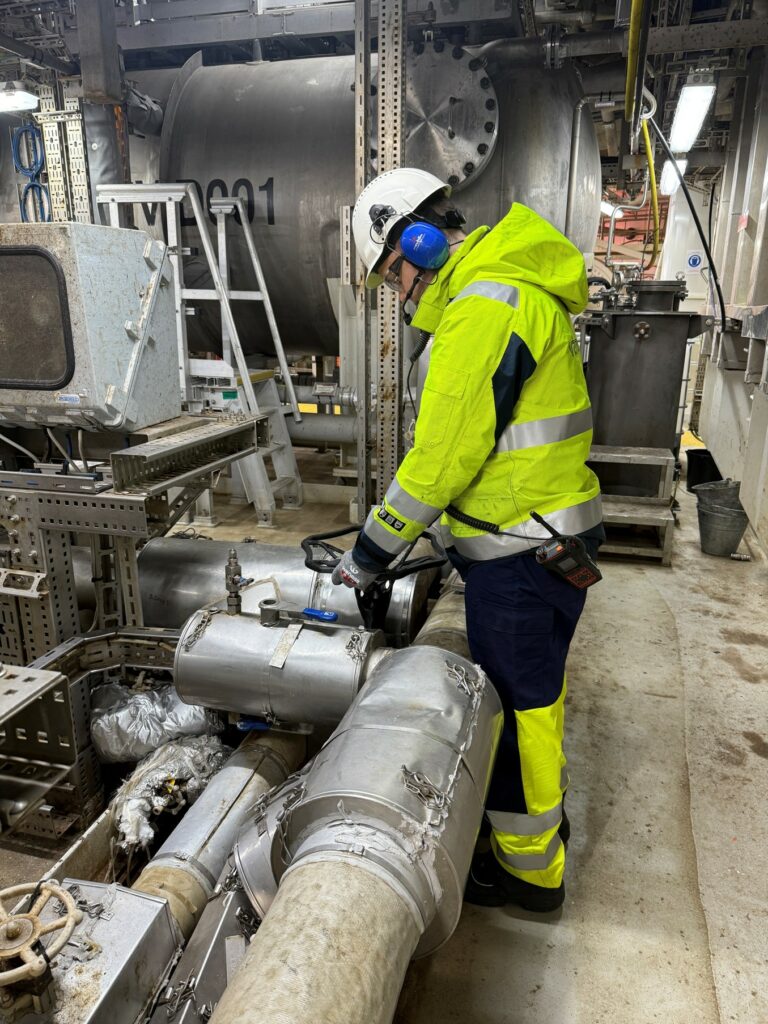 A technician working on industrial equipment at Vår Energi.