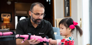Jorge M. Zuniga, Ph.D, helps Rue Gillespie put on her prosthesis before she is run through a series of tests on Wednesday, Jan. 15, 2020, in Omaha, Nebraska, at the Gillespie home. (Ryan Soderlin/UNO) Jorge M. Zuniga, Ph.D, helps Rue Gillespie put on her prosthesis before she is run through a series of tests on Wednesday, Jan. 15, 2020, in Omaha, Nebraska, at the Gillespie home. (Ryan Soderlin/UNO)