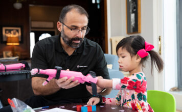 Jorge M. Zuniga, Ph.D, helps Rue Gillespie put on her prosthesis before she is run through a series of tests on Wednesday, Jan. 15, 2020, in Omaha, Nebraska, at the Gillespie home. (Ryan Soderlin/UNO) Jorge M. Zuniga, Ph.D, helps Rue Gillespie put on her prosthesis before she is run through a series of tests on Wednesday, Jan. 15, 2020, in Omaha, Nebraska, at the Gillespie home. (Ryan Soderlin/UNO)