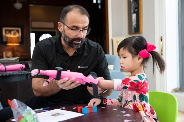 Jorge M. Zuniga, Ph.D, helps Rue Gillespie put on her prosthesis before she is run through a series of tests on Wednesday, Jan. 15, 2020, in Omaha, Nebraska, at the Gillespie home. (Ryan Soderlin/UNO) Jorge M. Zuniga, Ph.D, helps Rue Gillespie put on her prosthesis before she is run through a series of tests on Wednesday, Jan. 15, 2020, in Omaha, Nebraska, at the Gillespie home. (Ryan Soderlin/UNO)