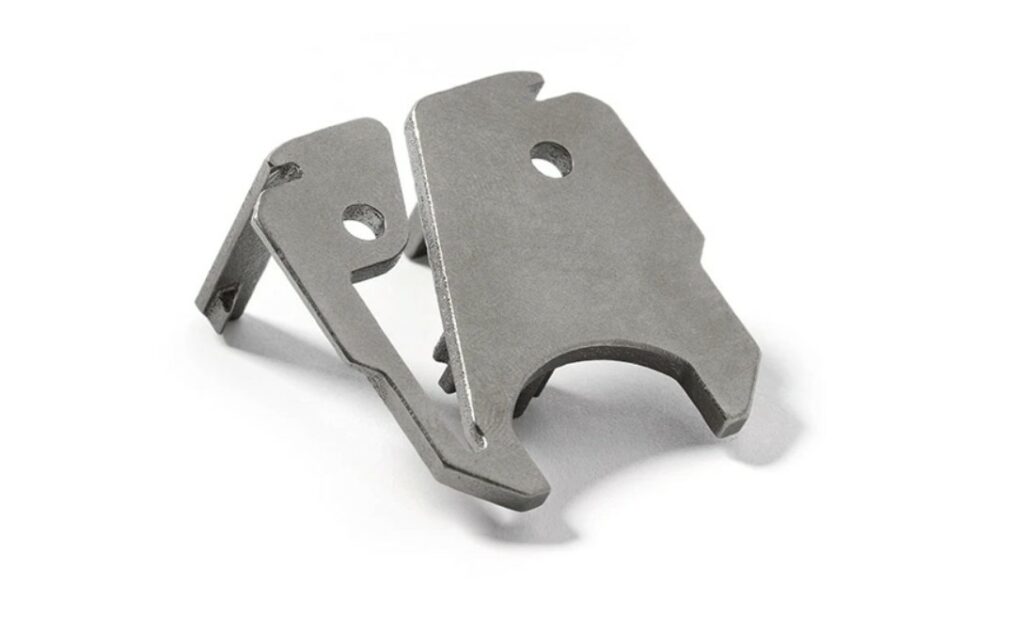 Titanium metal latch displayed against a white background.