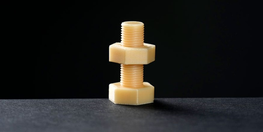 Printed threaded component with two nuts.