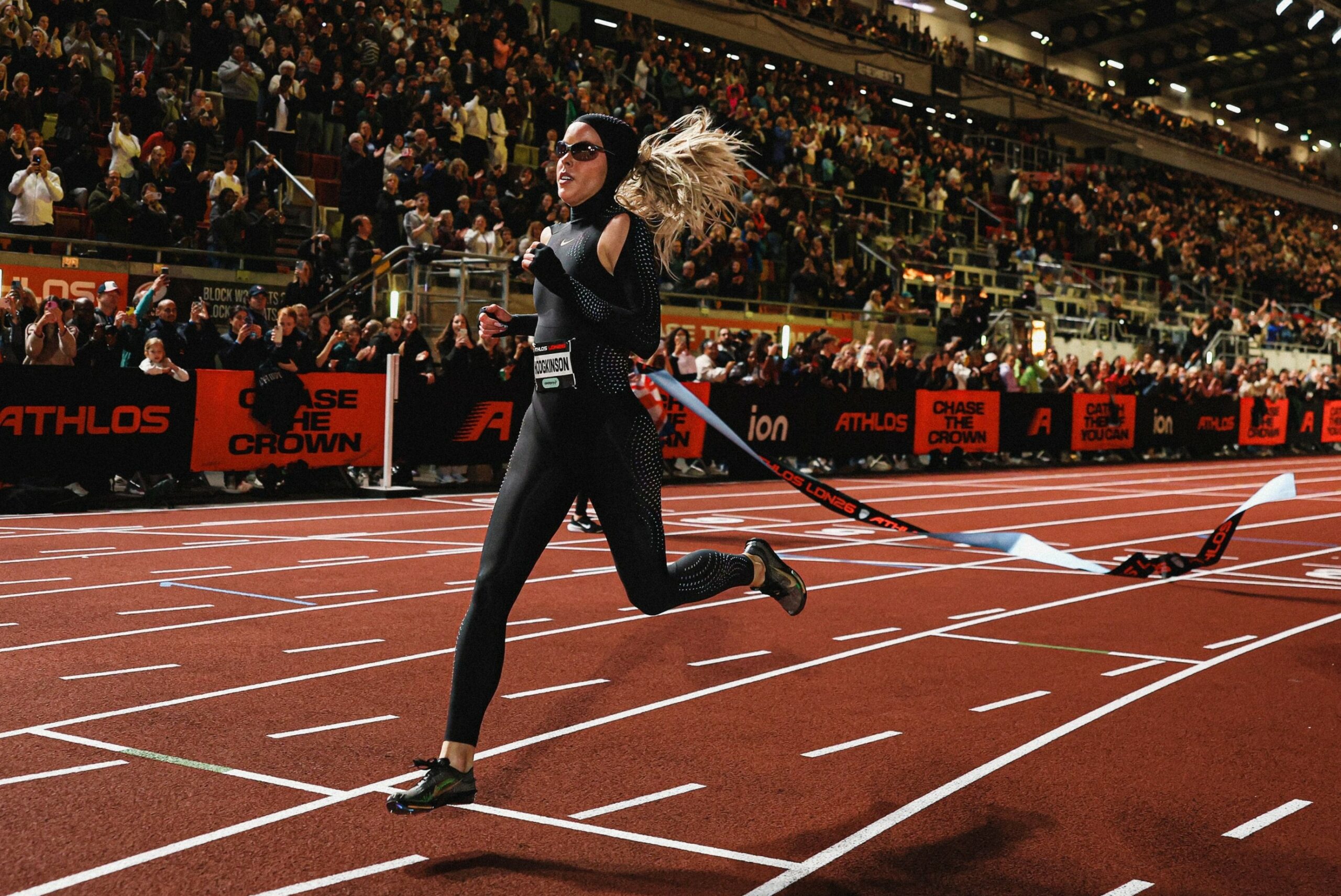 Keely Hodgkinson racing on a track in her black Nike speed suit.