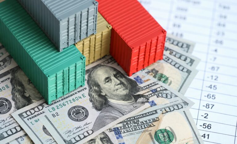 Cargo containers and US dollar banknotes.