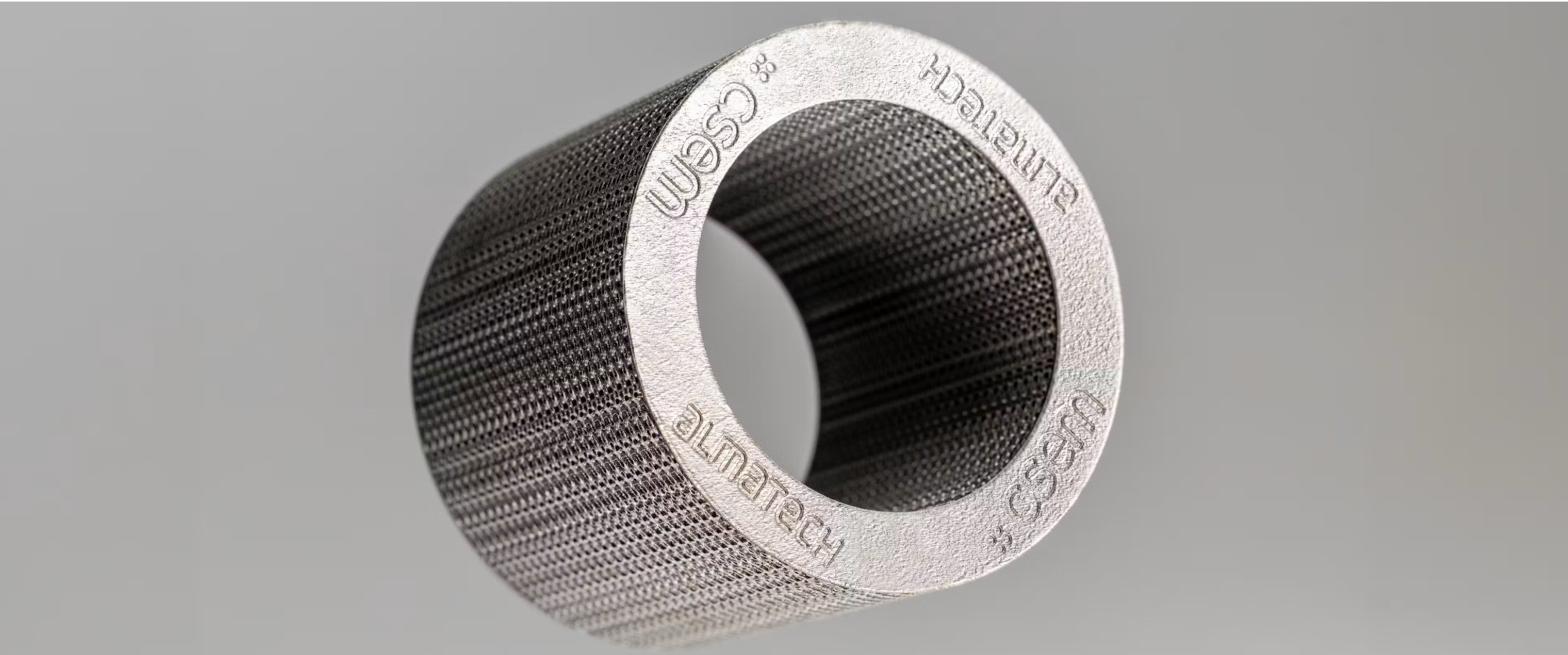 3D printed NiTi lattice cylinder engraved with the CSEM and Almatech logos, the RESHAPE shock absorber demonstrator