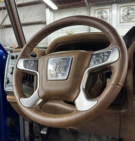 Steering wheel of Project REBORN #001 with a crowned bee emblem